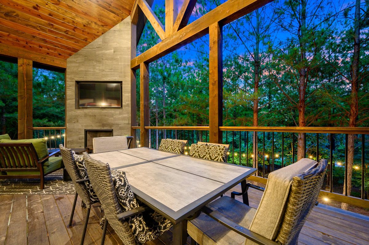 Covered deck with outdoor kitchen and dining